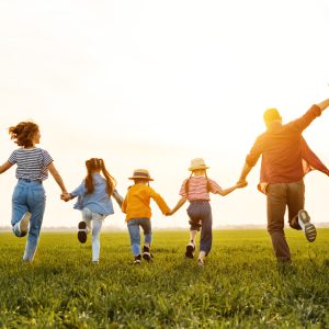 happy family running on the short grassland