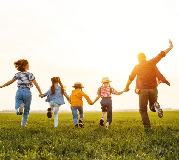 happy family running on the short grassland