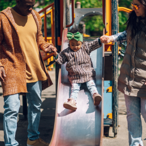 small family playing on the playground