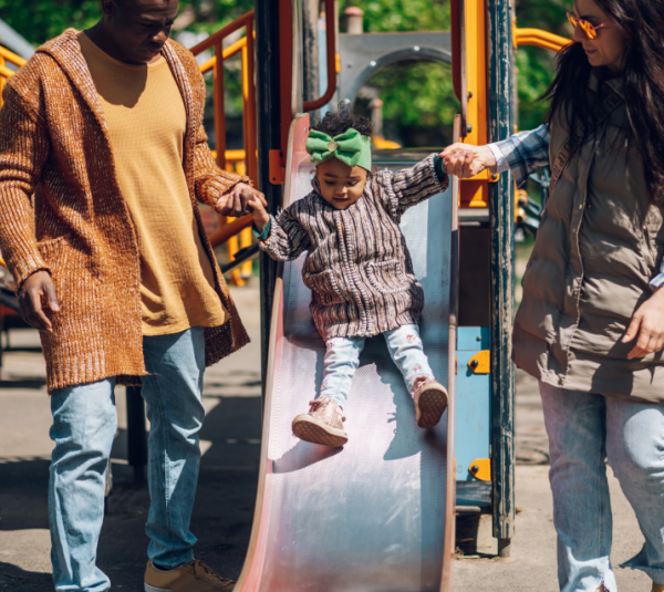 small family playing on the playground