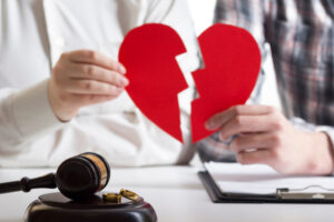 Hands of wife, husband signing decree of divorce