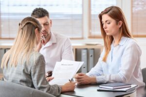 Young couple visiting divorce lawyer in office